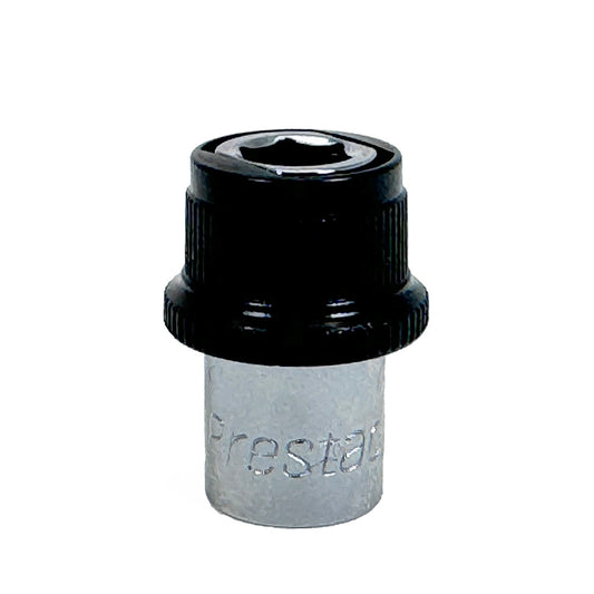 A close-up of a Prestacycle 1/4” Square to Hex Bits Quick Release Adapter, featuring a silver and black design with Prestacycle branding, shown next to a mini ratchet from the Prestacycle Bicycle Bit Set.