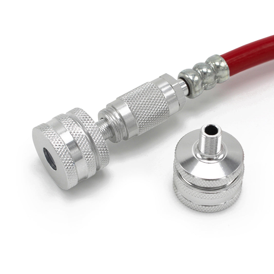 A close-up of the Prestacycle Big Presta Head, a metallic quick-connect fitting by Prestacycle, attached to a red hose with Urethane Elastomer Presta Gasket, and a matching connector piece on a white background.