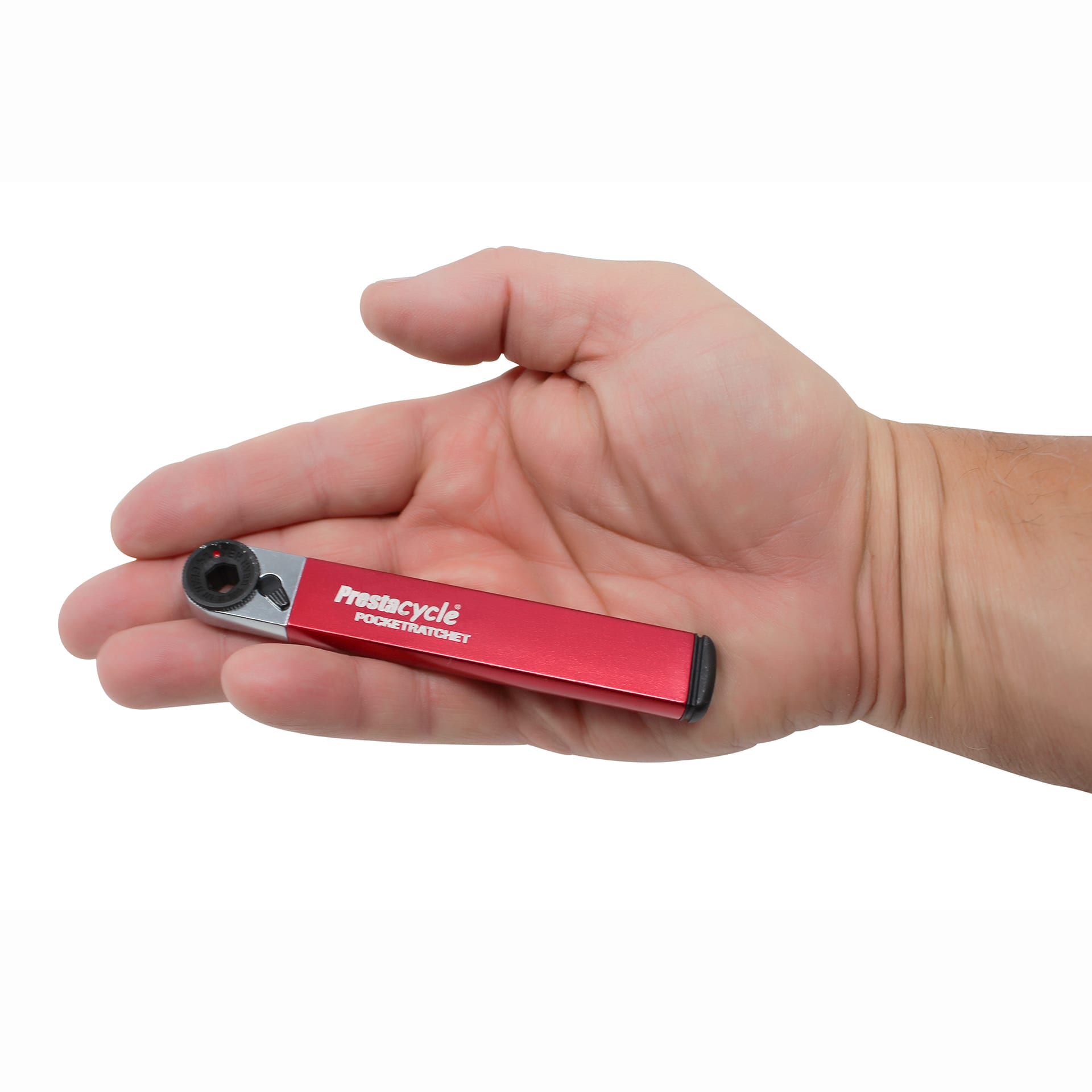 A hand holds the compact Prestacycle PocketRatchet, a pocket multi-tool with bits stored in the handle and a visible ratchet mechanism at one end.