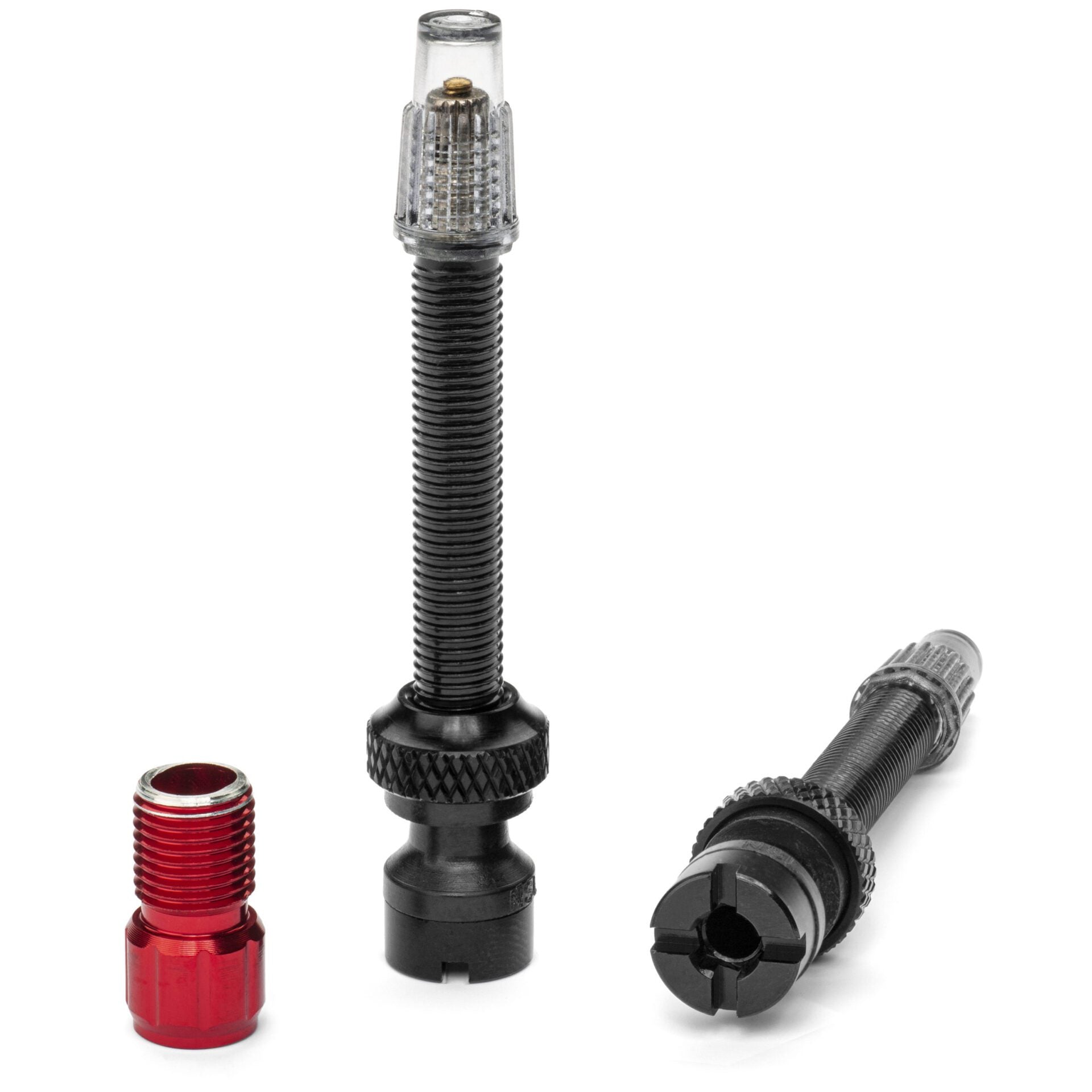 The Prestacycle Presta+ 50mm Tubeless Valves are shown: one upright with a clear cap, one lying down, and a separate red aluminum cap—perfect for bikes needing five-way airflow or use with a Prestadapter.