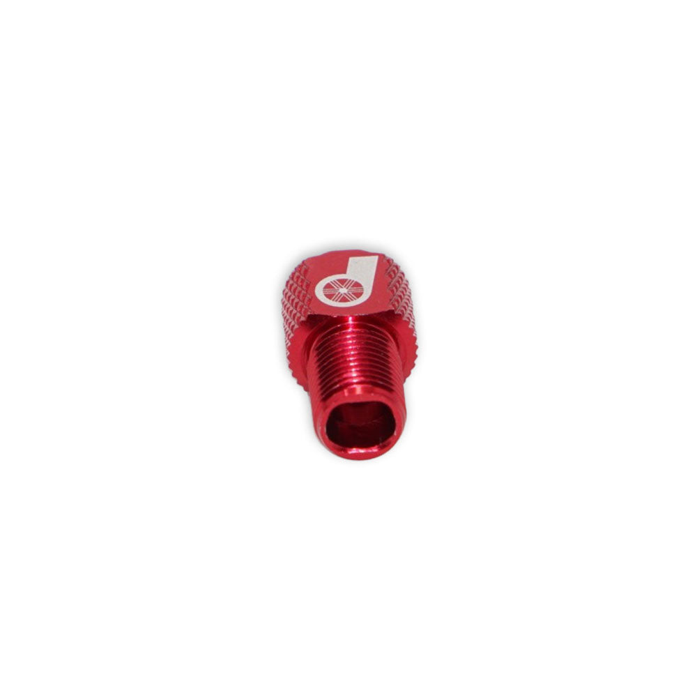 A small, red Prestacycle Prestadapter TUBELESS – Presta adapter and valve core remover, made from lightweight alloy with a threaded opening and white logo on top, shown on a plain white background.