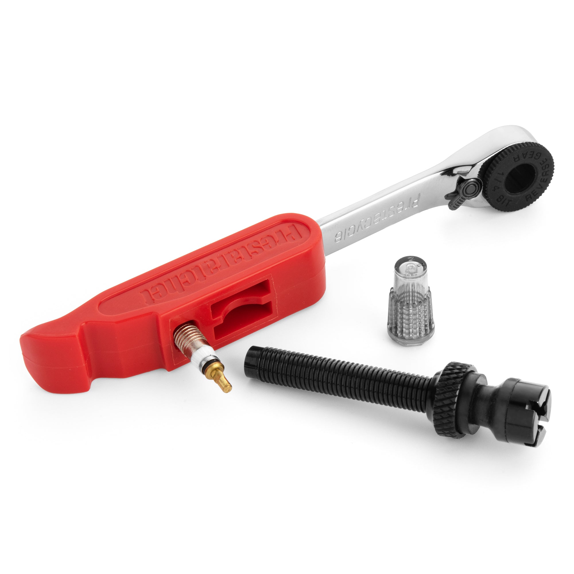 The Prestacycle Prestaratchet GO Multi-tool Kit features a red plastic presta valve core tool, reversible ratchet, black valve stem, small valve core, and clear valve cap—arranged on a white background.