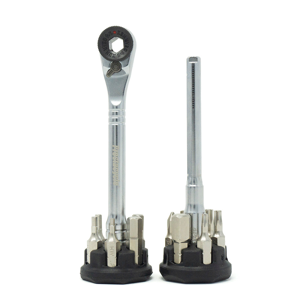 Two Prestacycle Pro T-Handle Kits stand upright on black holders, each with multiple 1/4 inch bits around the base. The silver Prestacycle wrenches provide versatile functionality and a sleek, modern look.