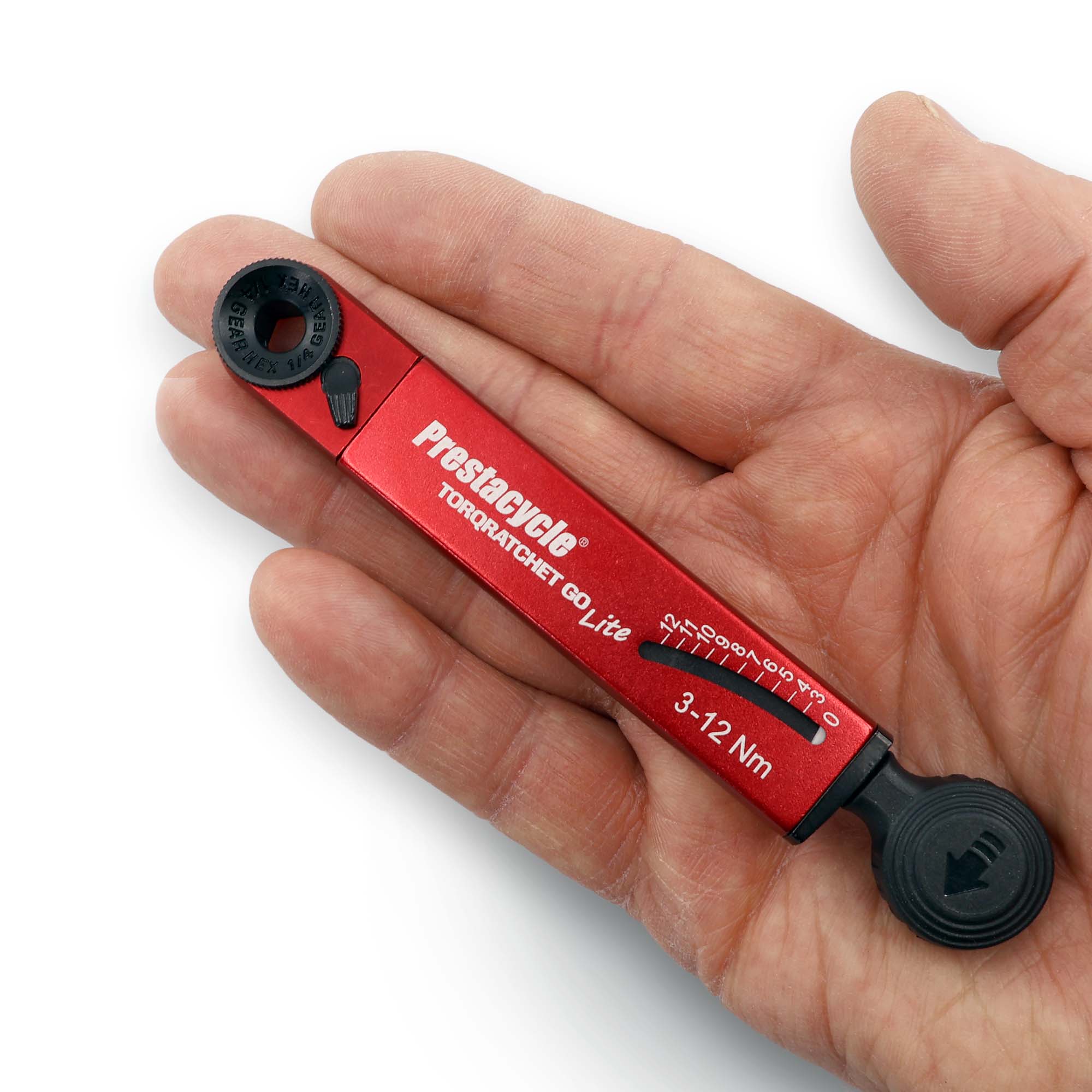 A hand holds a red Prestacycle TorqRatchet GO Lite, a portable 3~12Nm torque multi-tool ratchet, showcasing its adjustable settings and measurement scale.