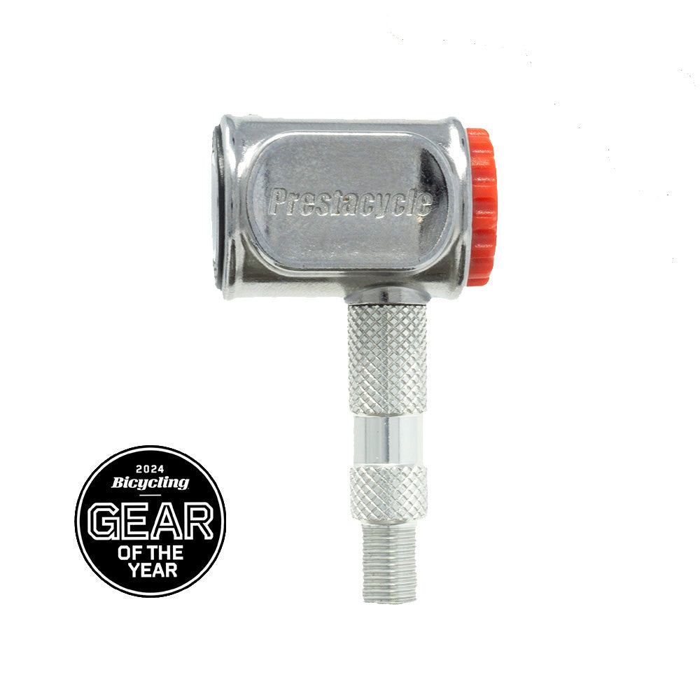 Close-up of the Prestacycle Pro Presta Head bike tool by Prestacycle, featuring an instant no-loss disconnect and a red knob, shown beside a Bicycling 2024 Gear of the Year badge on a white background.
