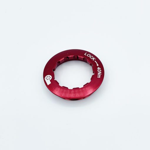 A red metal Prestacycle UniBlock PRO Cassette (12-Speed, Campagnolo, for HG11/HG10 Freehub) lockring with notched edges and LOCK – 40NM in white text is shown on a plain white background—ideal for securing your cassette.