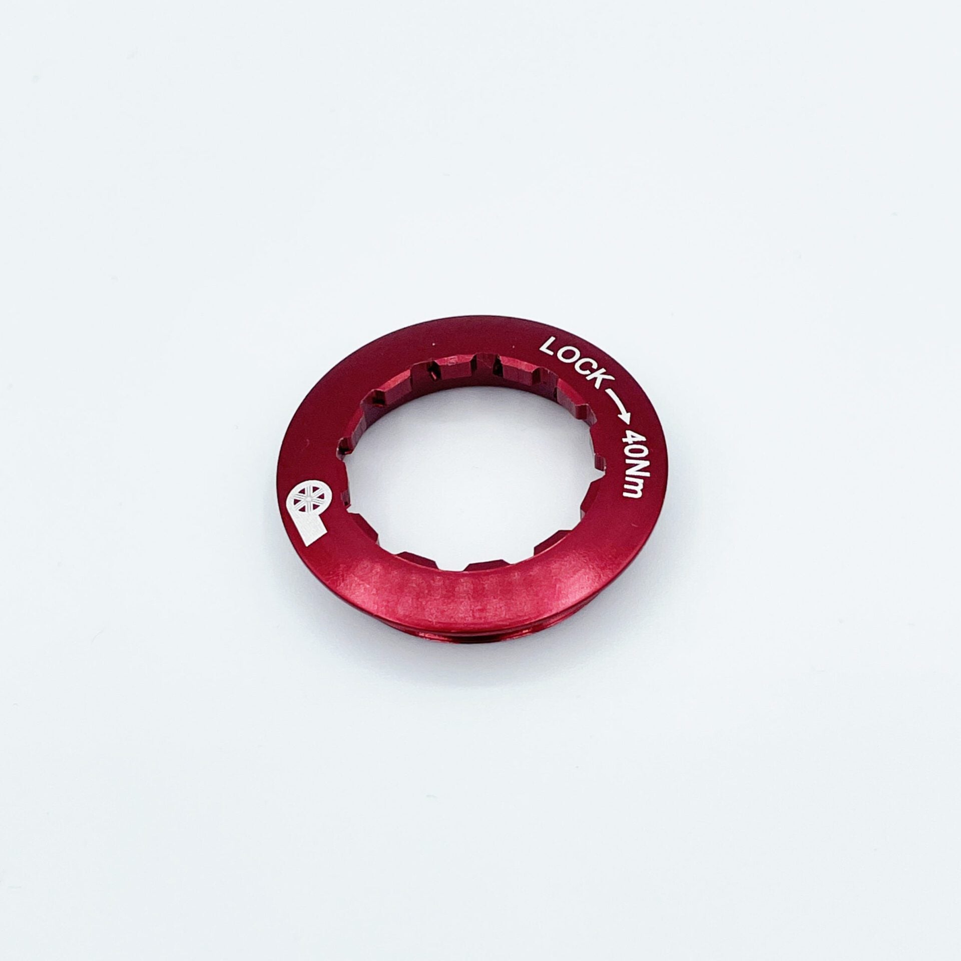A red metal ChroMoly lockring with notched edges, white “LOCK → 40NM” text, is shown on a white background. Compatible with Shimano HG12 12-speed systems. For use with Prestacycle UniBlock PRO Cassette (12 Speed) by Prestacycle.