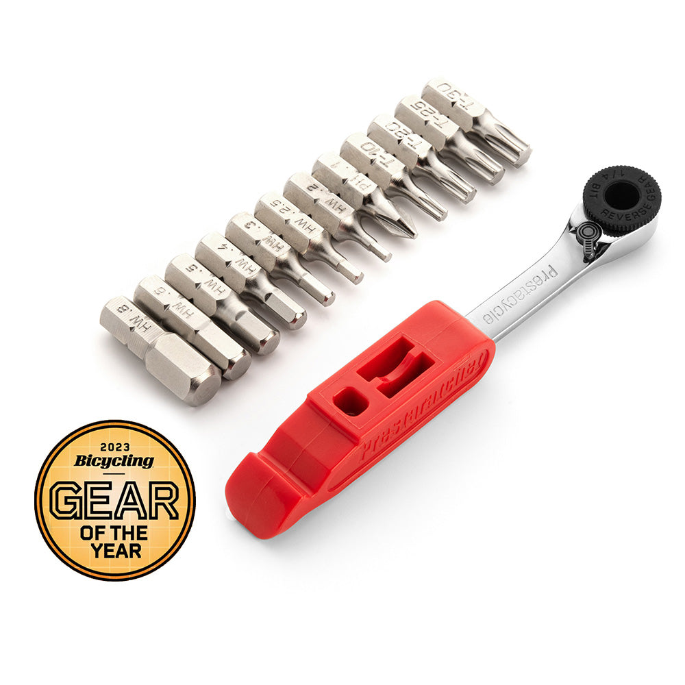The Prestacycle Prestaratchet GO is a compact 6-in-1 bicycle multi-tool wallet kit with a red handle, multiple metal driver bits, and a presta valve core tool. A gold 2023 Bicycling Gear of the Year badge appears in the bottom left corner.