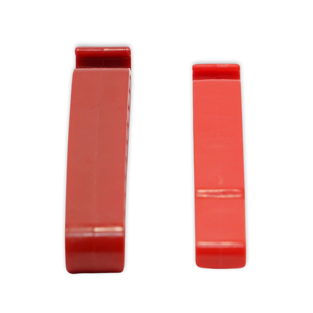 Two red Prestacycle Prestalever Third-Hand Tire Holders stand upright side by side on a white background, with flat tops and sides. The left holder is wider and thicker than the right one.