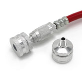 A close-up of the Prestacycle Big Presta Head, a metallic quick-connect fitting by Prestacycle, attached to a red hose with Urethane Elastomer Presta Gasket, and a matching connector piece on a white background.