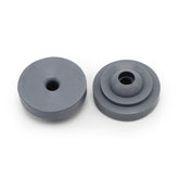 Two round, gray Prestaflator Big Presta Head Gaskets from Prestacycle—perfect Presta Head replacements—include one with a single hole and another with a stepped design, both displayed on a white background.