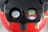 Close-up of a Prestacycle Prestaflator Digital Gauge for Air Compressors & Floor Pumps with an analog tank pressure gauge, both showing clear dials and connectors, set against a vivid red background.