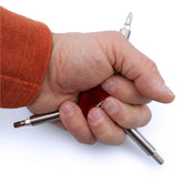 A person with an orange sleeve holds the Prestacycle Three Way Y Bits Tool by Prestacycle, featuring a red handle and multiple replaceable bits, against a white background.