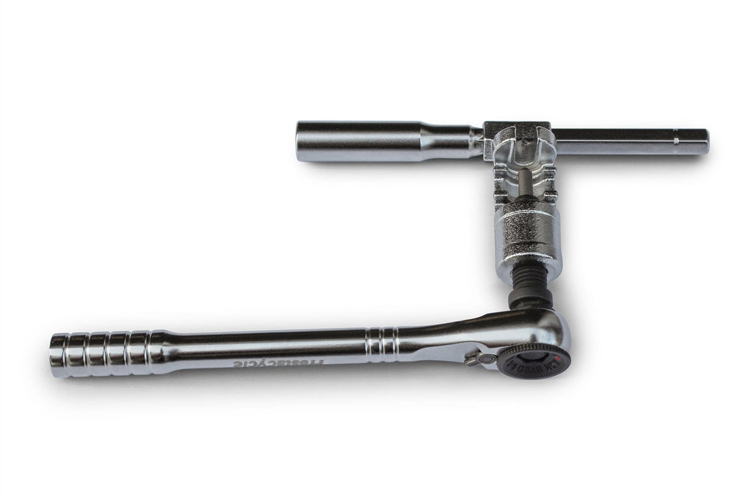 The Prestacycle PrestaRatchet Chain Accessory, featuring a metal ratchet wrench with socket and T-bar handle in an L-shape, is ideal as a portable chain tool for cyclists.