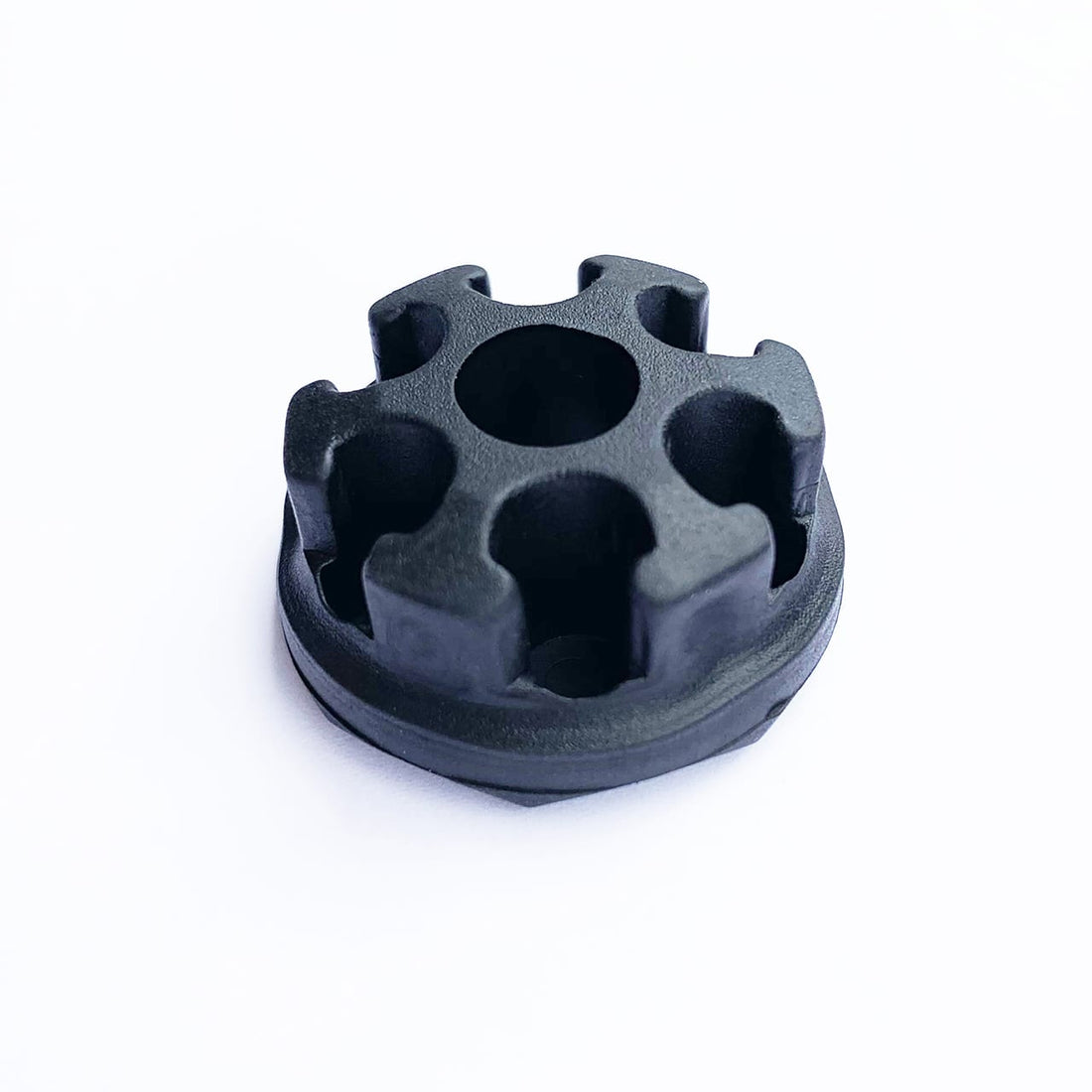 The Prestacycle Round Shaft Mount 6 Bits Holder by Prestacycle is a black, round plastic or rubber piece with a central hole and six notches, shown on a white background.