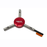 The Prestacycle Chain Cleaning & Lubricating Brush Specialty Bit features a red circular center, three silver arms, and an orange brush—an essential portable tool for cleaning your bike chain.