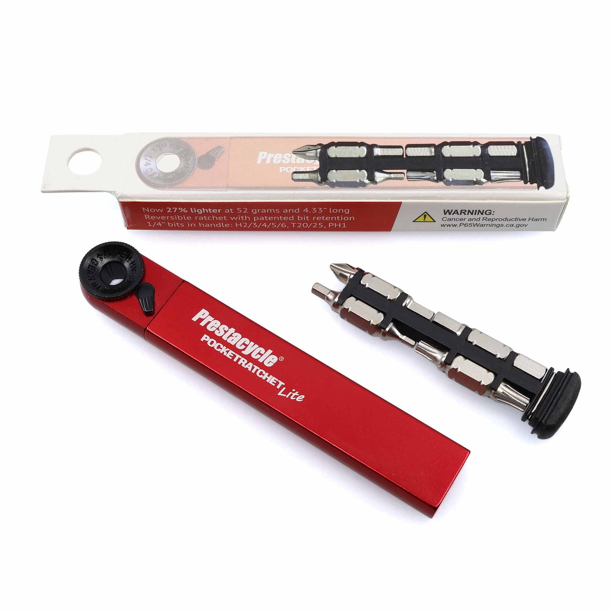 The Prestacycle PocketRatchet Lite, a compact red pocket multi-tool with handle-stored bits, is displayed with several bits attached and its white-and-red packaging set behind it on a white background.