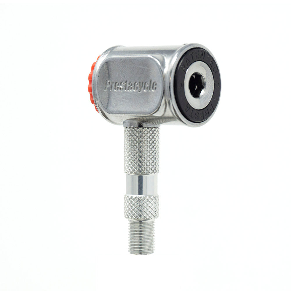 A close-up of the Prestacycle Pro Presta Head by Prestacycle, a metallic bicycle pump head with a knurled grip, auto-lock mechanism, red button, and black circular valve opening. Shown against a plain white background.