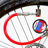 The Prestacycle Prestaflator PRO Digital Bicycle Tire Inflator, featuring a Pro Presta Head and red hose, is attached to a bike valve, showing 41.1 PSI on its blue backlit screen.
