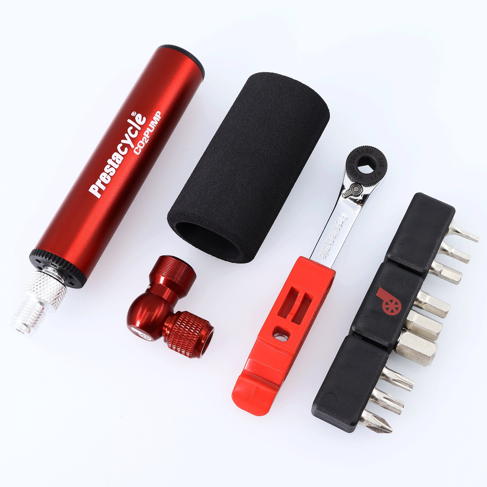 The Prestacycle GO Bundle is an ultralight 8-in-1 bike tool kit featuring a red CO2 pump, black foam sleeve, red valve adapter, red tire lever, ratcheting multi-tool wrench with interchangeable bits—all arranged on a white background.