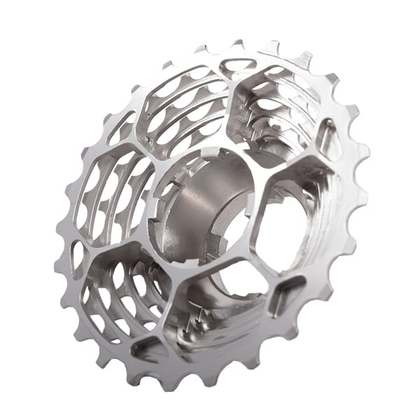 A close-up of the Prestacycle UniBlock PRO Cassette (10 Speed) by Prestacycle, featuring a metallic chromoly steel build, hollow honeycomb design, and evenly spaced teeth along the edge.