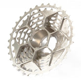 The Prestacycle UniBlock PRO Cassette (12 Speed) by Prestacycle features a metallic, hollow, lightweight design with a lattice structure and multiple sprockets for high performance and reduced weight.