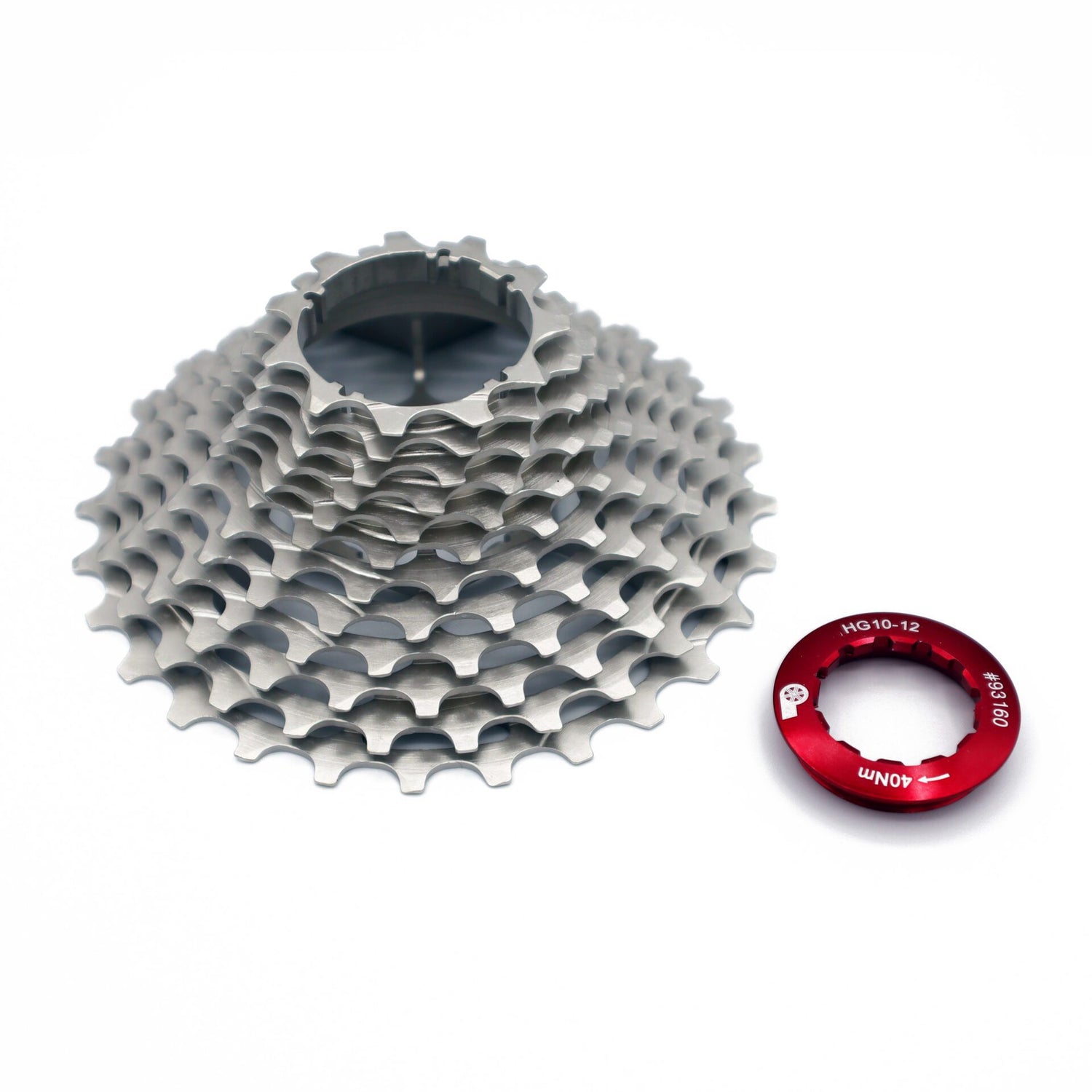 A Prestacycle UniBlock PRO Cassette (12-speed) in silver ChroMoly steel sits beside a red lockring on a white background.