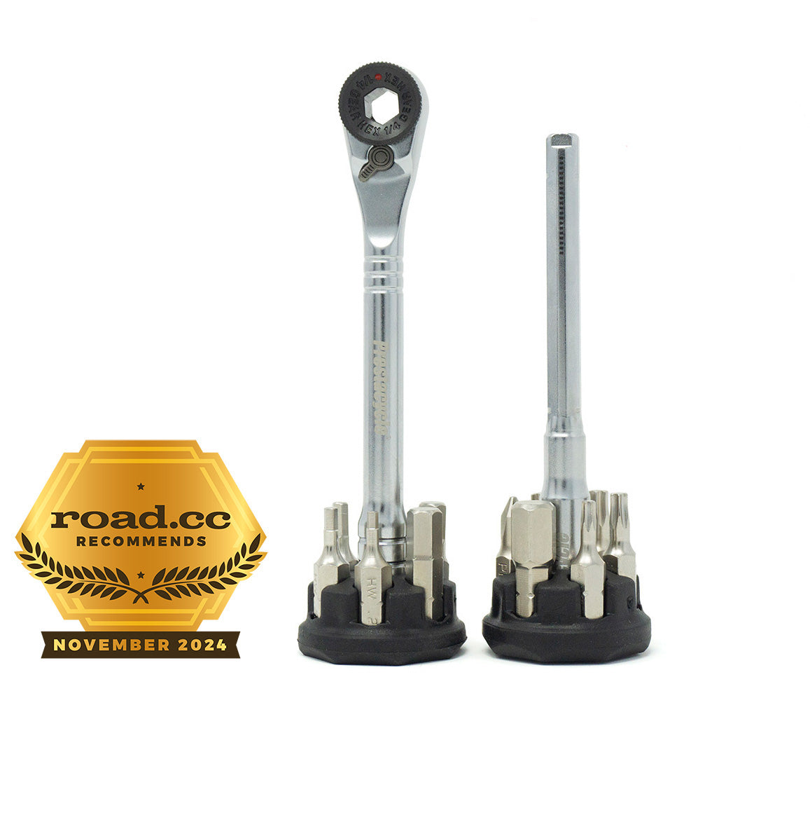 Two Prestacycle Pro T-Handle Kit tools with assorted 1/4 inch bits stand upright on a white background. A gold &quot;road.cc recommends November 2024&quot; badge is displayed on the left side of the image.